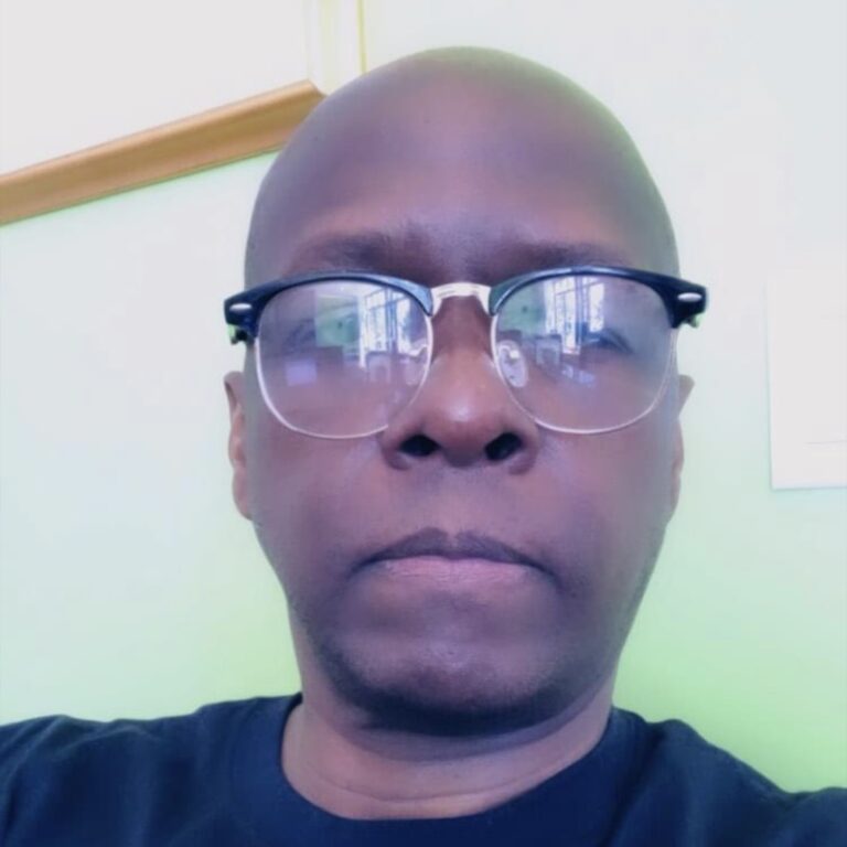Mel Rook in glasses at home